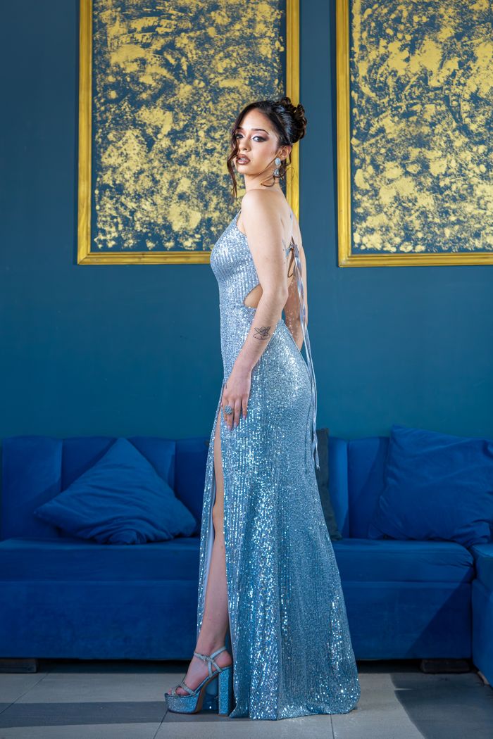 Stylish woman posing in a glistening silver dress, perfect for fashion and glamour photography.